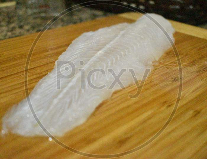 Fish Fillet In A Wooden Board Before Cooking.