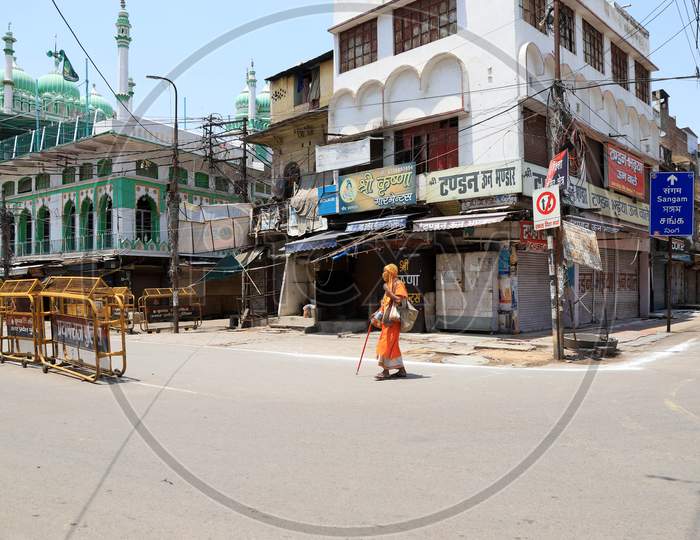 A sadhu walks on the empty road during a government-imposed nationwide lockdown as a preventive measure against the Coronavirus, in Prayagraj, May 3, 2020.