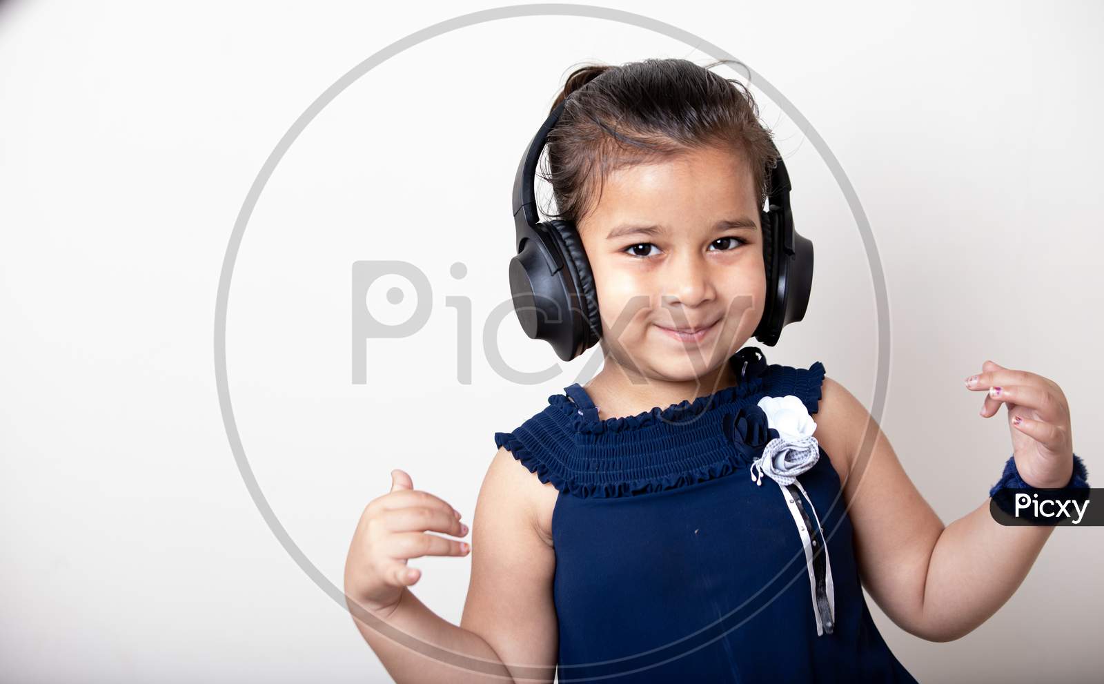 Cute Little Girl With Headphones Listening Music Giving Cute Expression
