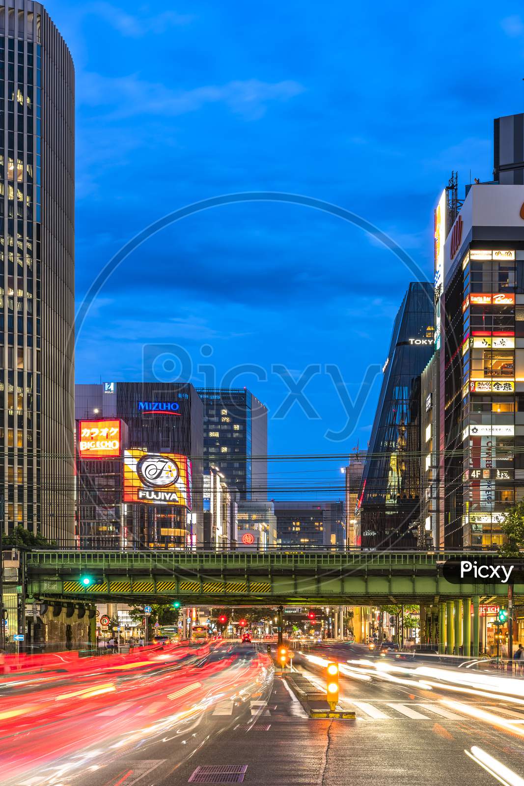 Night View Of The Harumi Street Leading To Ginza District Near To The Entrance Of The Hibiya Park (日比谷公園 Hibiya Kōen) In Chiyoda City Of Tokyo In Japan. Harumi Street Is Leading From The Iwaida Bridge Intersection In Chiyoda Ward To The Shinonome Intersection In Koto Ward.