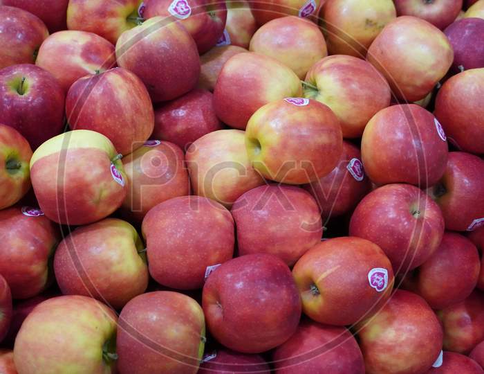 Bunch Of Pink Apples On Boxes In Supermarket. Apple Put On Sale Shelves In The Supermarket. Fresh Ripe Apples Displayed Beautifully. India