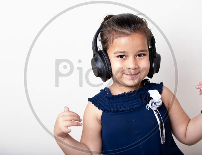 Cute Little Girl With Headphones Listening Music Giving Cute Expression