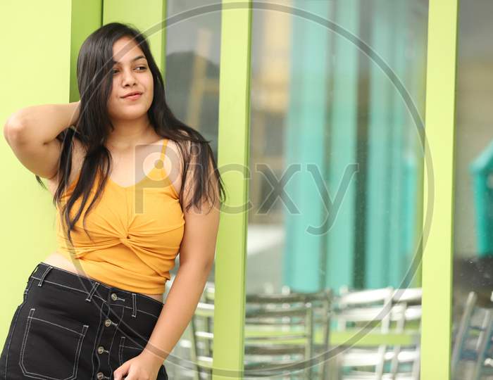 Indian Teenage Girl Lifestyle Pic outside of shop in yellow and black outfit