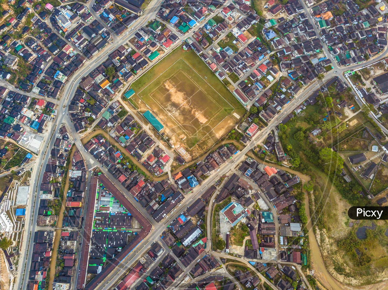 An aerial view of a playground in between an urban area