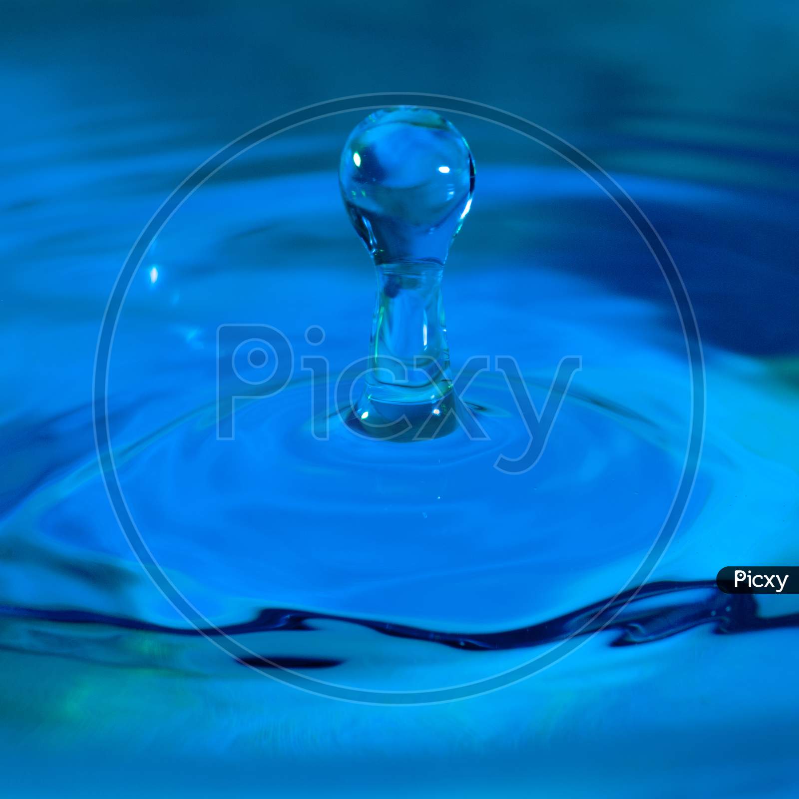 close up photo of water drops splashing creating abstract shape