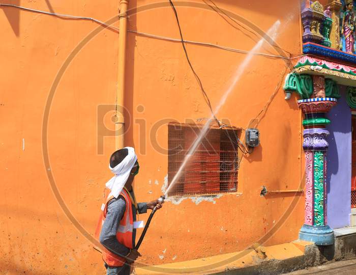 A worker of municipality sanitizes a temple during a government-imposed nationwide lockdown as a preventive measure against the COVID-19 or Coronavirus, in Prayagraj, May 3, 2020.