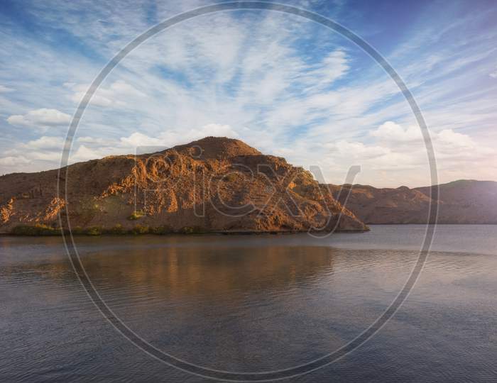 Beautiful scenic landscape of mountains with reflections over the lake in jebel sifah.
