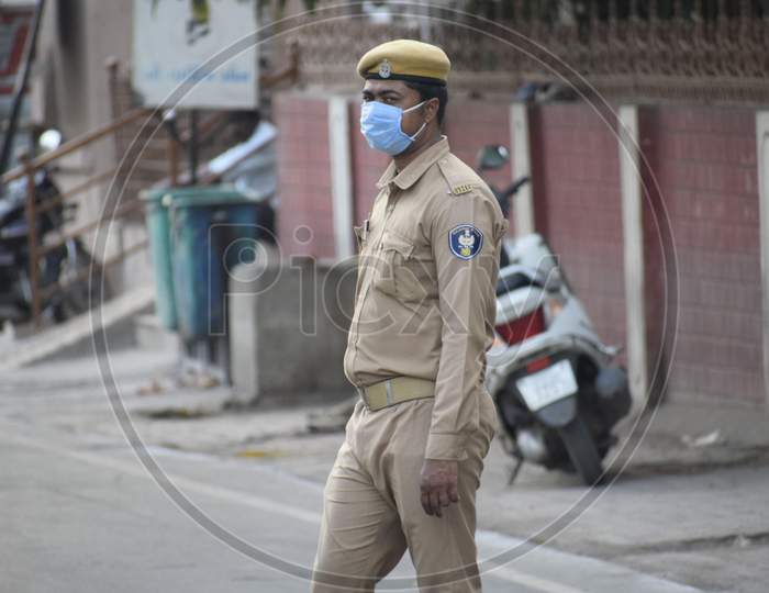 Bharuch, Gujarat / India - April 05, 2020: Covid 19 Corona Virus 21 days lockdown in India. Police on duty to stop people from roaming in the city and make them follow lockdown to prevent the spread of Corona.