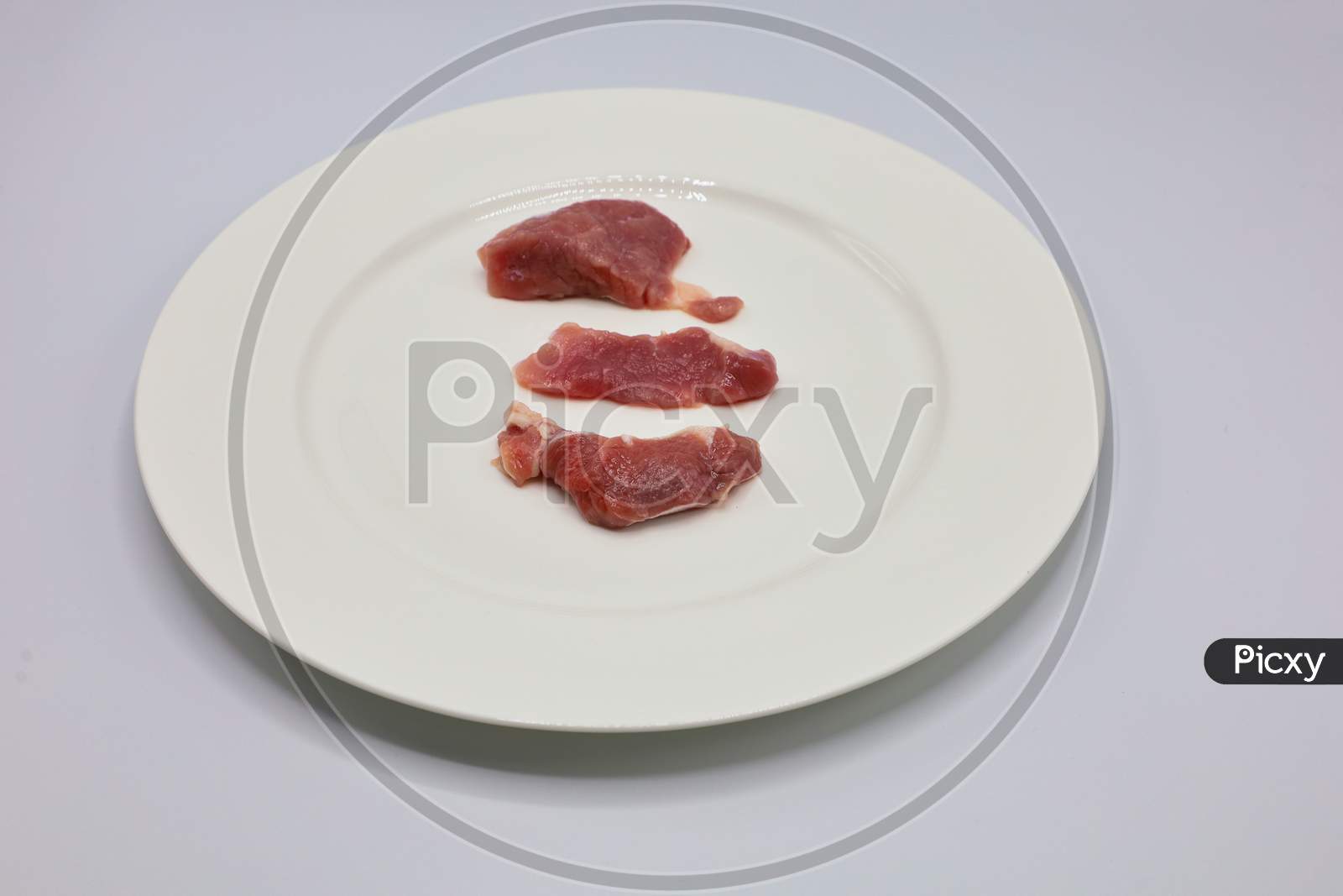 Meat, pork, slices pork loin on a white background