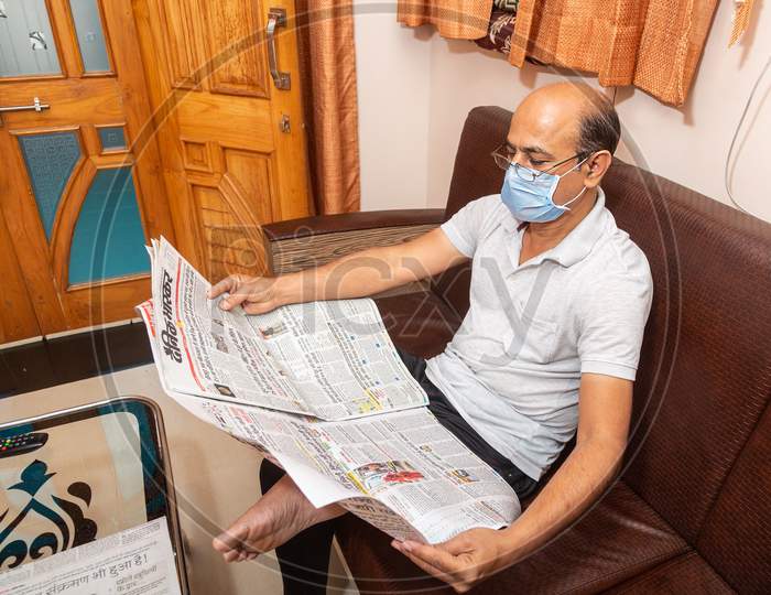Jodhpur, Rajashtbn, India. 30 March 2020. Man Wearing Mask Reading Newspaper, Man Quarantine, Isolated, Stay Home Stay Safe, Coronavirus, Covid-19 Outbreak I