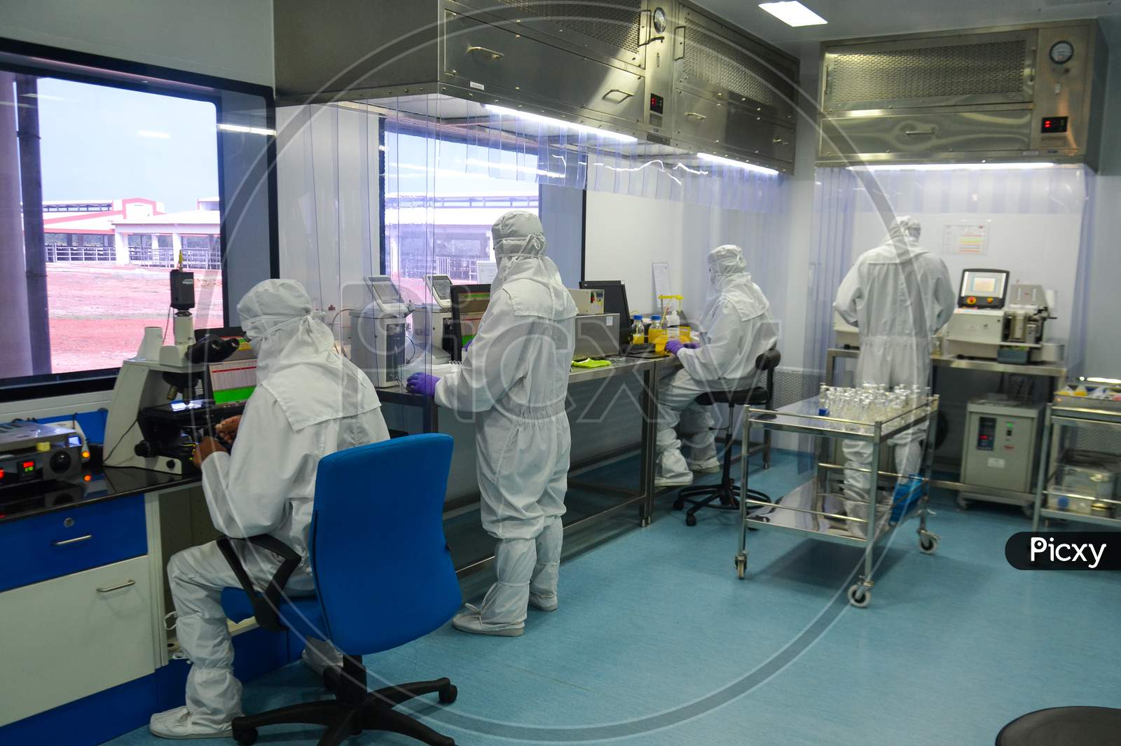 Scientists in protective coverall doing research at a laboratory in India, while maintaining quality standards and protocols.