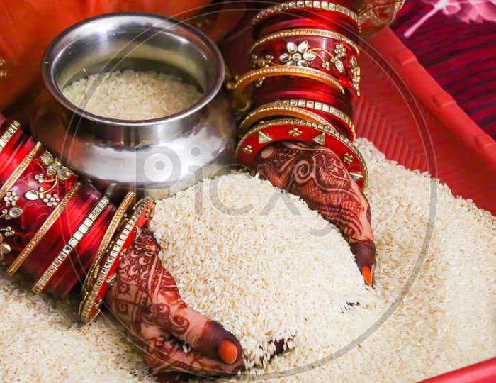 Indian bride holding rice in hands