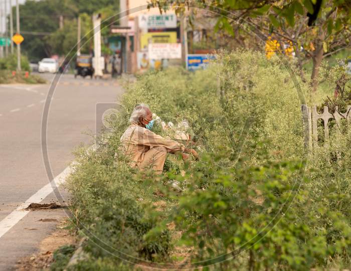 Ambala City, Haryana/India -04/30/2020  Poor Old man Sitting on Road side mask on Face During Covid-19/Corona virus Pandemic.
