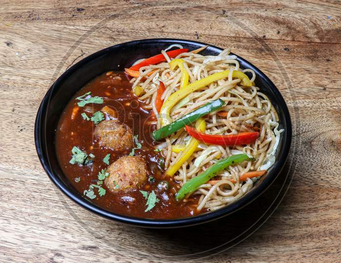 Manchurian with noodles in bowl