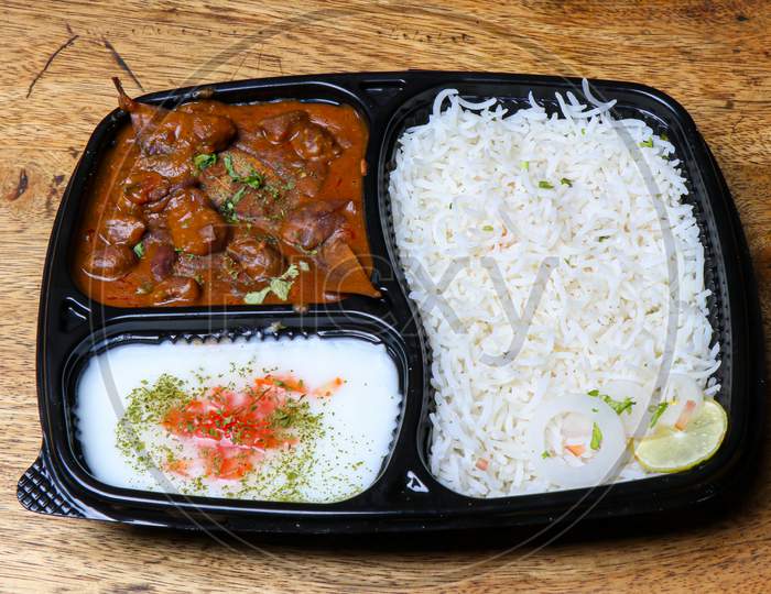 Indian food item rajma chawal in disposable tray