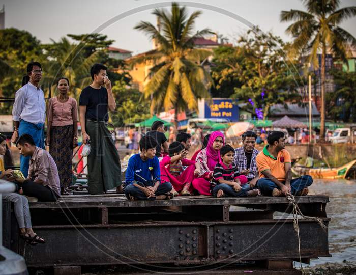 People waiting for a Boat near a Boat Yard