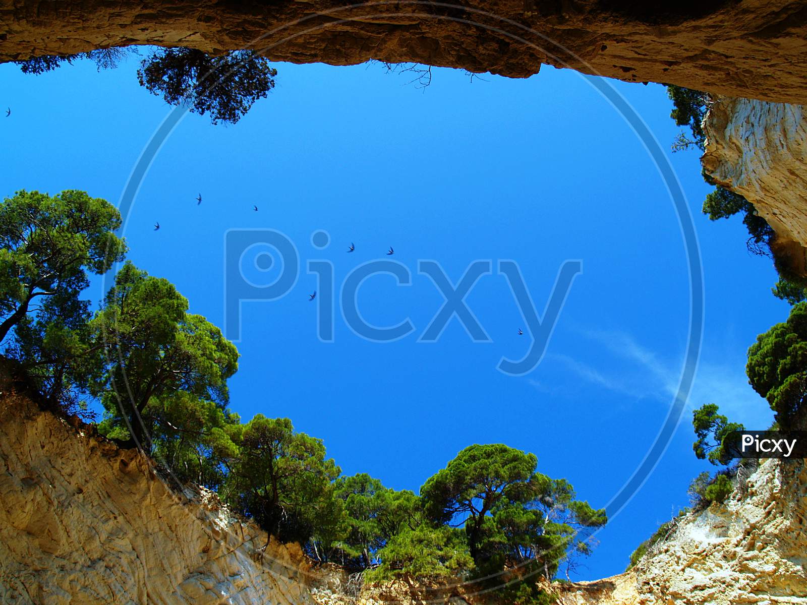 Sky view through natural cave hole Grotta Sfondata in natural area of Gargano National Park