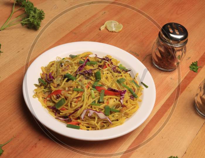 Noodles : stir fried noodle with tofu, carrots and green vegetables. Vegetarian food / Chinese food.