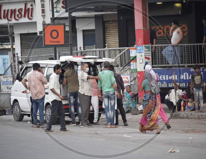 Bharuch, Gujarat / India - April 05, 2020: Covid 19 Corona Virus 21 days lockdown in India. People helping the needy ones by feeding them food during the lockdown in India due to Corona Virus Pandemic.