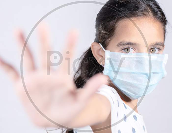 Stop Coronavirus Or Covid 19 Outbreak Concept - Young Teenager Girl In Medical Protective Mask Shows A Stop Gesture With Hand - Girl Held Out Palm With Fear, Concept Of Quarantine Or Home Isolation.