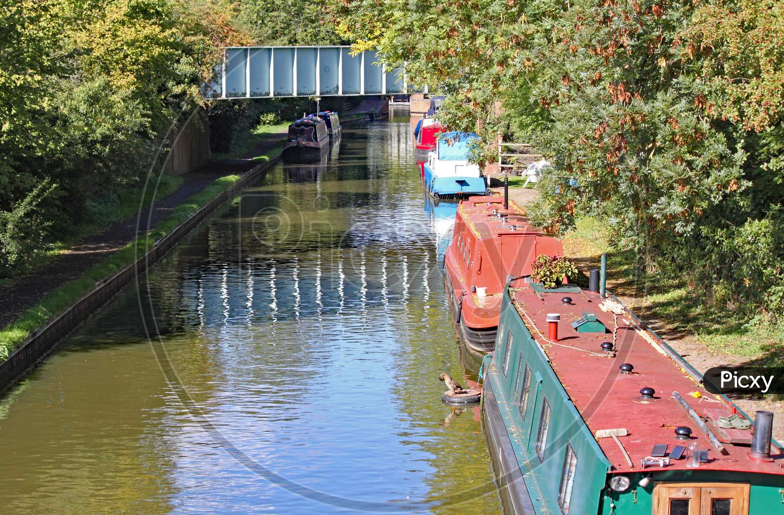 Barges Moored To The Bank On The Grand Union Canal At Lapworth In Warwickshire, England