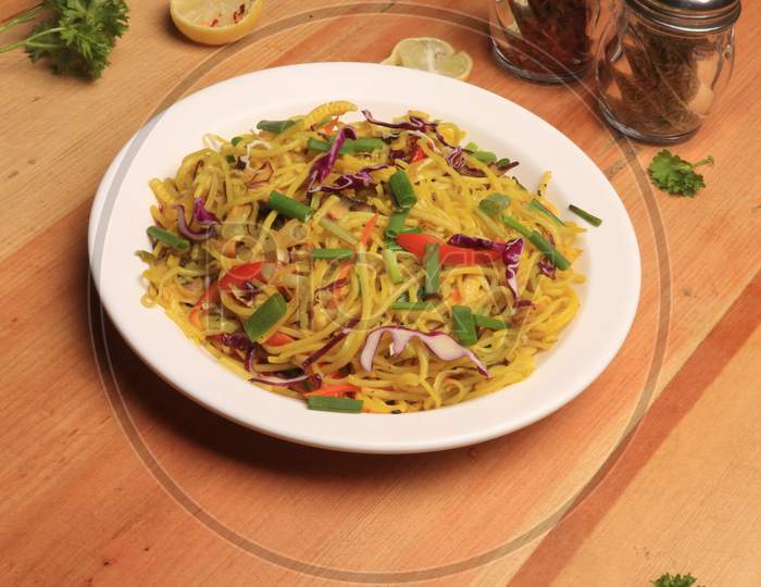 Noodles : stir fried noodle with tofu, carrots and green vegetables. Vegetarian food / Chinese food.