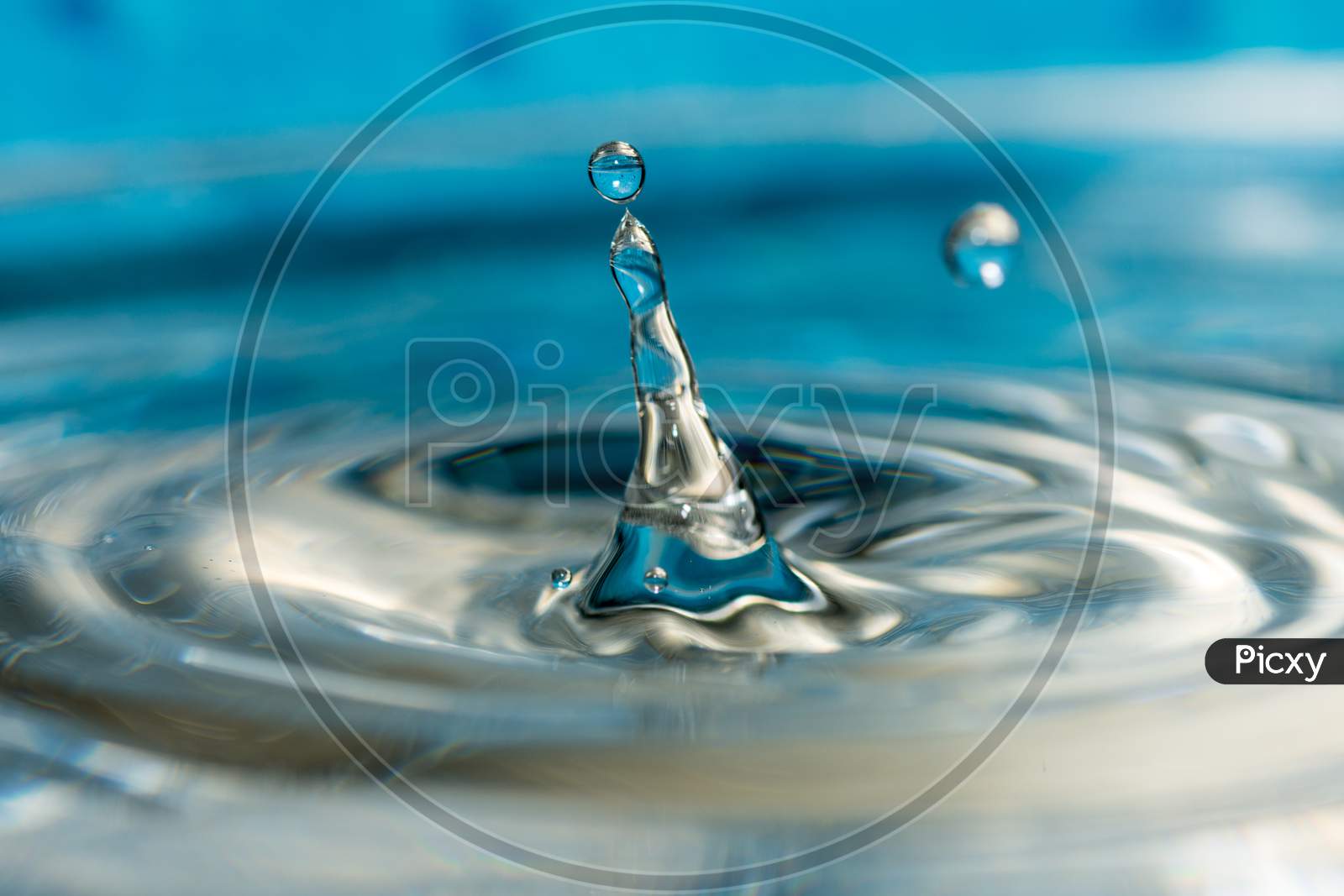 close up photo of water drops splashing creating abstract shape