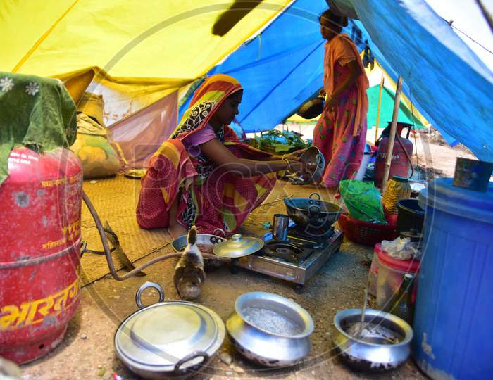 A  Flood Affected Woman Cooks Inside Her Makeshift Shelter On A Railway Track In Hojai District Of Assam On May 30,2020.