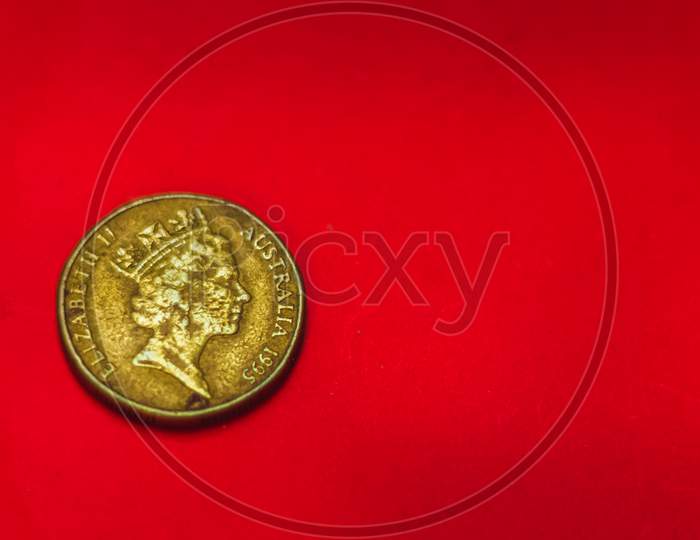 Australian Dollar Coin Back Side Isolated On Red Background With Soft Blurry And Space For Copy Text. One Dollar Coin 1995 Australian Currency. Old Coins Collections Worldwide.Queen Elizabeth Coin.