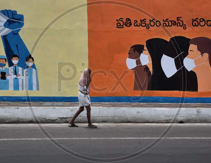 A Man Walks Past A Mural Of Awareness About Wearing A Face Mask,During The Ongoing Coronavirus Lockdown, In Vijayawada.