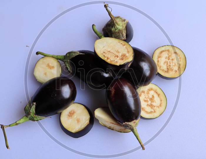 Fresh Raw Sliced Purple Eggplant Brinjal or Eggplant isolated on white background