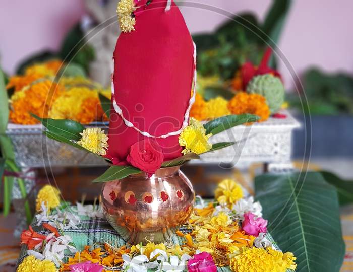 Copper Kalash with coconut and mango leaf with floral decoration on a white background. essential in hindu puja
