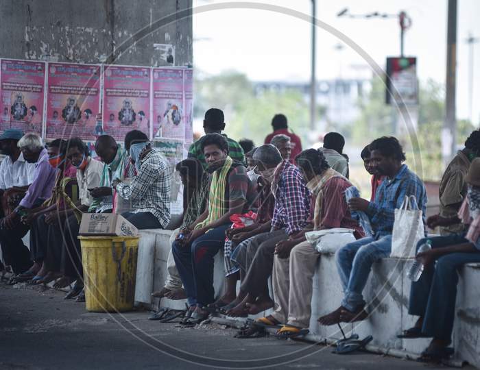 Migrant Laborers Wait Under A Flyover For Food, During The Ongoing Coronavirus Lockdown, In Vijayawada.