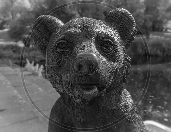 Stuttgart-Rohr, Germany - July 8, 2017: The Park This Is A Metal Bear In Front Of A Small Lake In The Park Of Rohr. Rohr Is An Outer Area Of Stuttgart. Stuttgart Is A Big City In The South Of Germany.