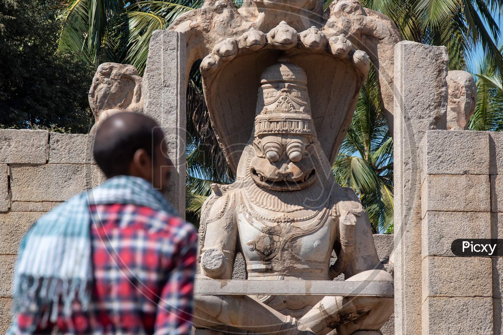 Narasimha Swamy Temple in Hampi with a Visitor in the Foreground