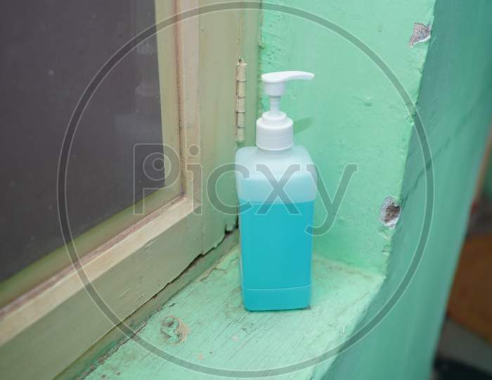 A hand sanitizer bottle with the green background