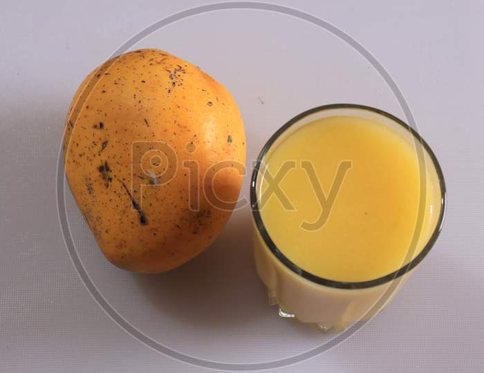 Fresh Yellow Mango fruit and juice isolated on white background