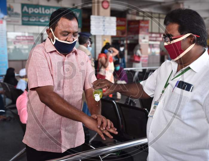 A Passenger Gets His Hands Sanitized Before Boarding A Bus At Pandit Nehru Bus Station, During The Ongoing Coronavirus Lockdown, In Vijayawada.