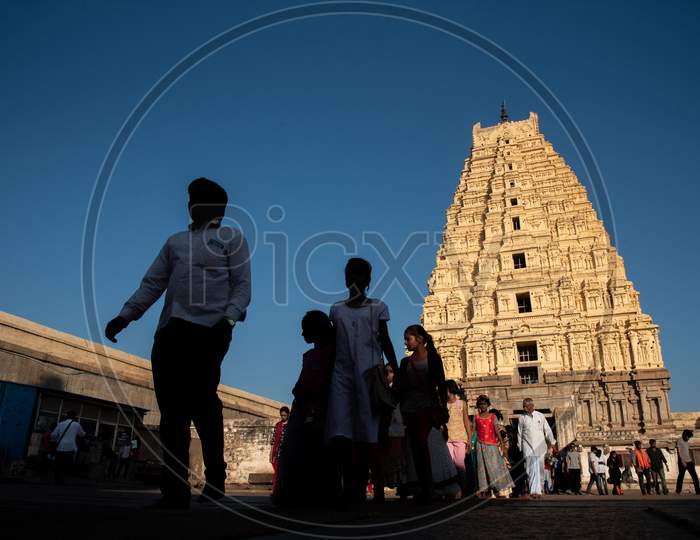 Selective Focus on Virupaksha Temple Gopuram with People in Foreground