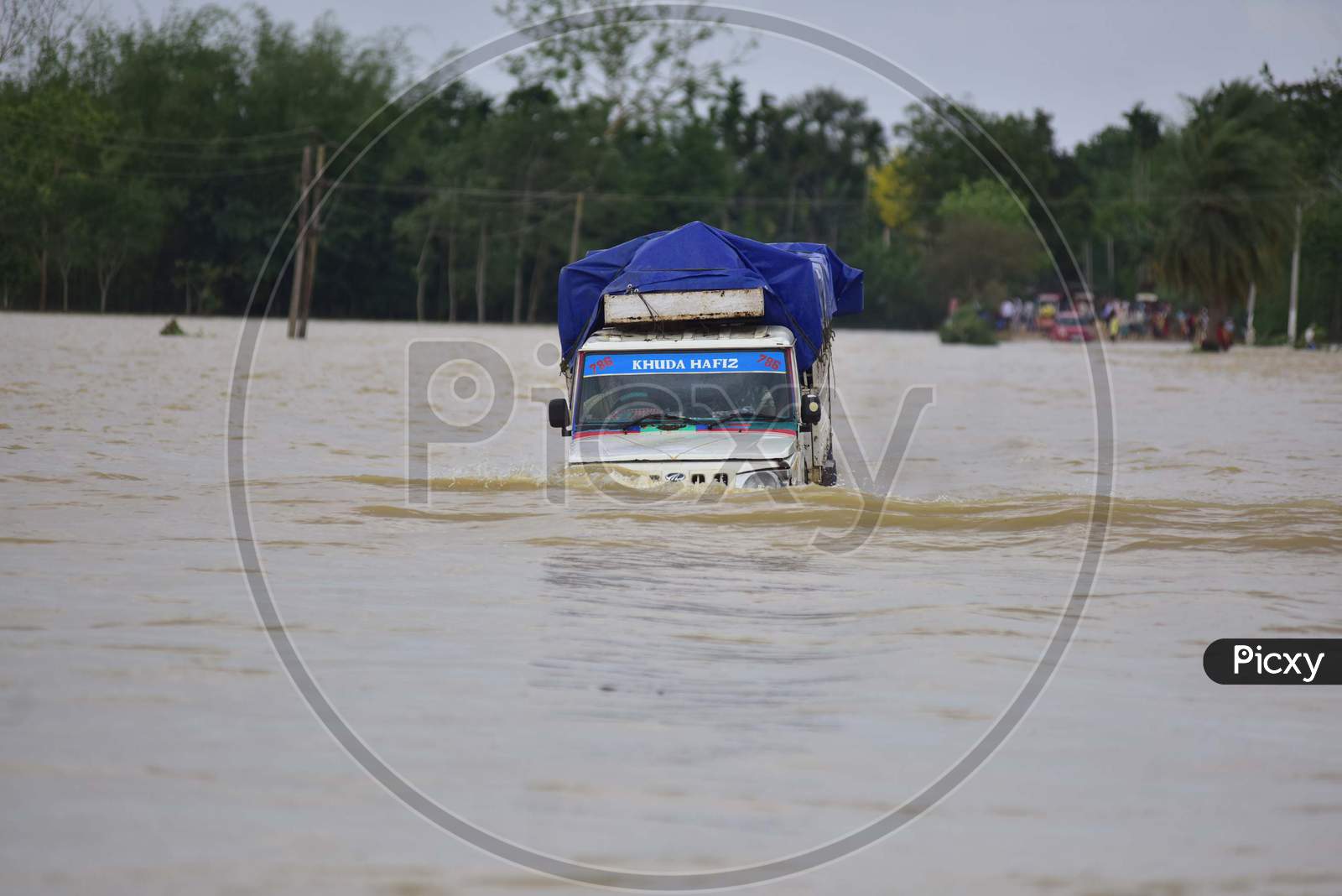 A Vehicle Wades Through A Flooded Area In Hojai District Of Assam On May 30,2020.