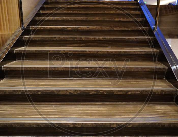 Luxurious Staircase With Marble Steps And Decorative And Ornamental Iron And Glass Railings. Elegant Historical Stairs In A Luxury Interior Inside A Hotel.