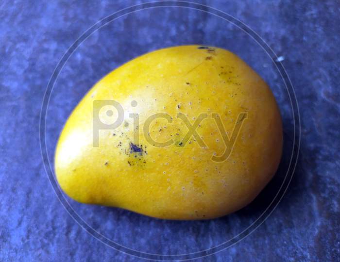 fresh sweet yellow mango isolated on stone background
