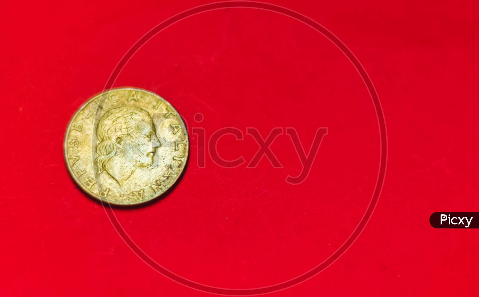 Italian 200 Lire Coin.Back Side Of Old Used Two Hundred Italian Lire, 1983. Vintage Bronze Coin Isolated On Red Background With Space For Text Copy. Repvbblica Italiana 200