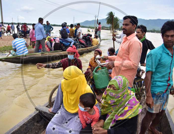 Flood Affected Villagers Are Transported In A Boat To A Safer Place In Hojai District of Assam On May 30,2020