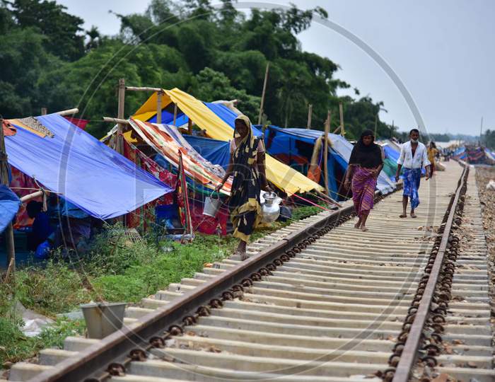 Flood Affected  Villagers walk besides their Makeshift Shelter  Near A Railway Track In Hojai District Of Assam On May 30,2020
