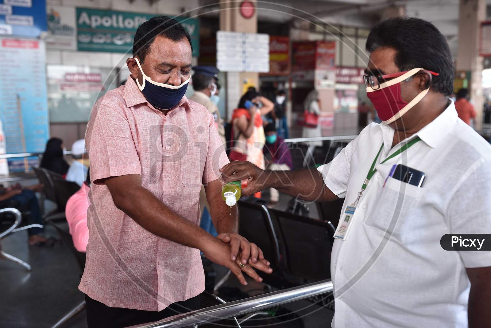 A Passenger Gets His Hands Sanitized Before Boarding A Bus At Pandit Nehru Bus Station, During The Ongoing Coronavirus Lockdown, In Vijayawada.