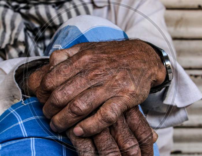 Close Up Of Hands Of An Old Man Sitting.