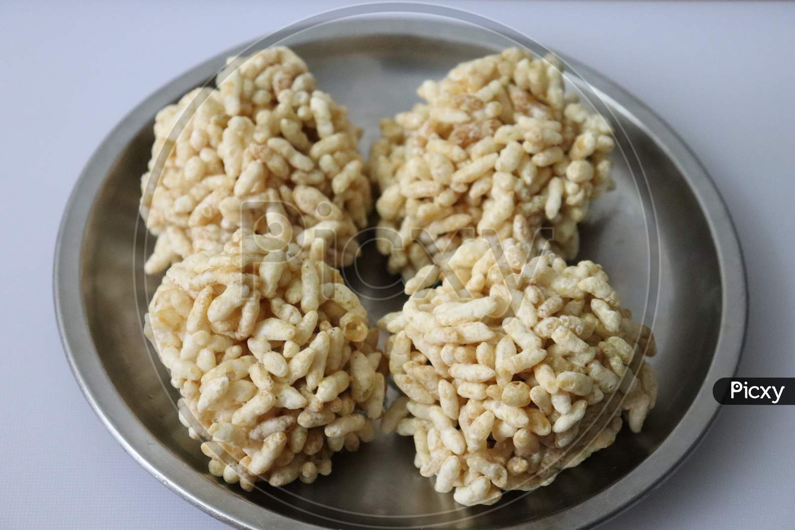 Puffed rice laddu isolated on a white background
