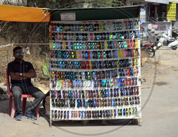 Hawker selling sunglasses by the roadside