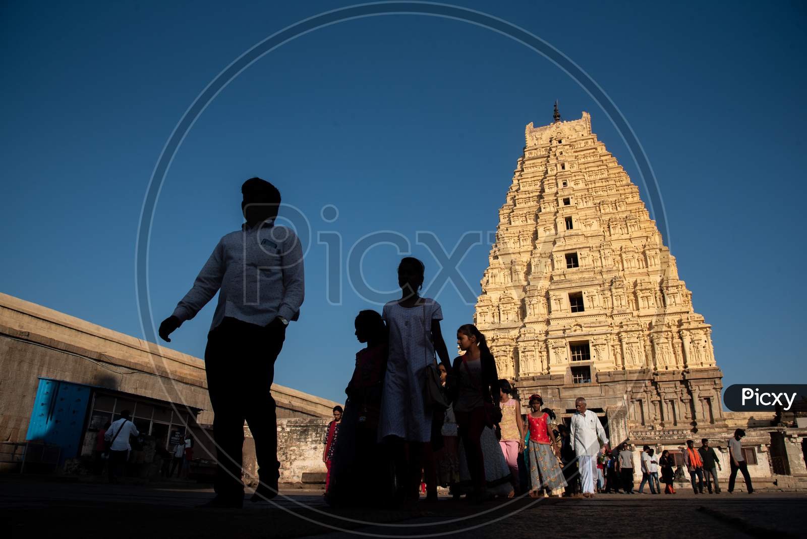 Selective Focus on Virupaksha Temple Gopuram with People in Foreground